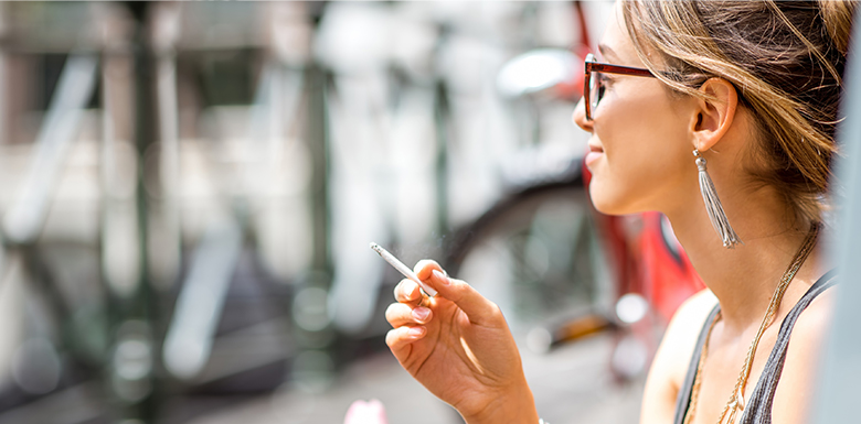 Smiling woman smoking marijuana