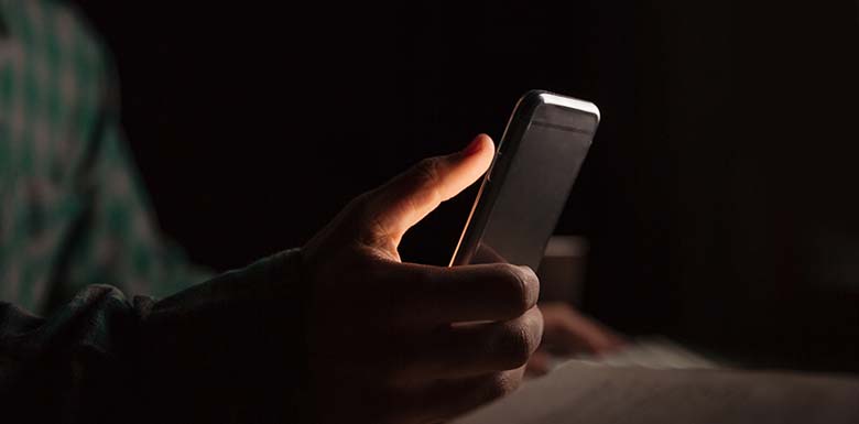 Man using phone in the dark